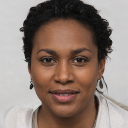 Joyful black young-adult female with short  brown hair and brown eyes