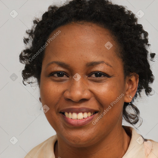 Joyful black adult female with medium  brown hair and brown eyes