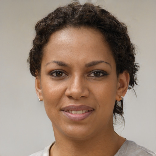 Joyful black young-adult female with short  brown hair and brown eyes