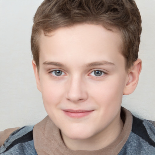 Joyful white child male with short  brown hair and grey eyes