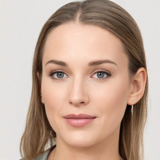 Joyful white young-adult female with long  brown hair and blue eyes