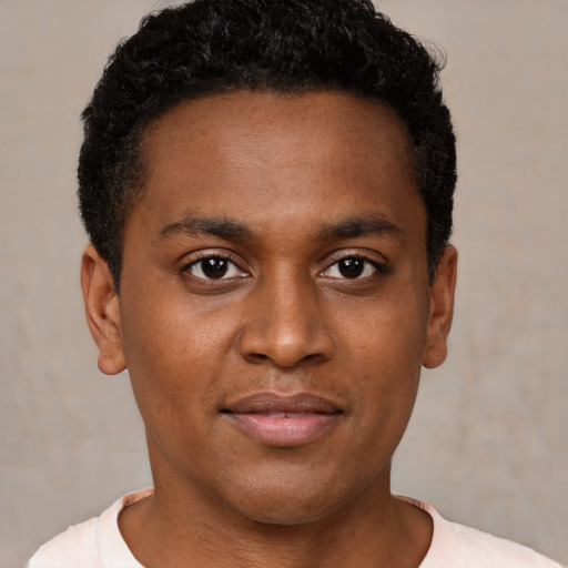 Joyful black young-adult male with short  black hair and brown eyes