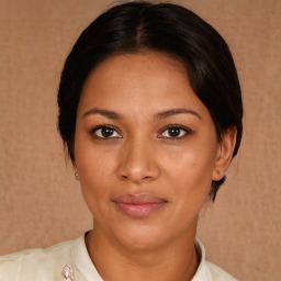 Joyful latino young-adult female with medium  brown hair and brown eyes