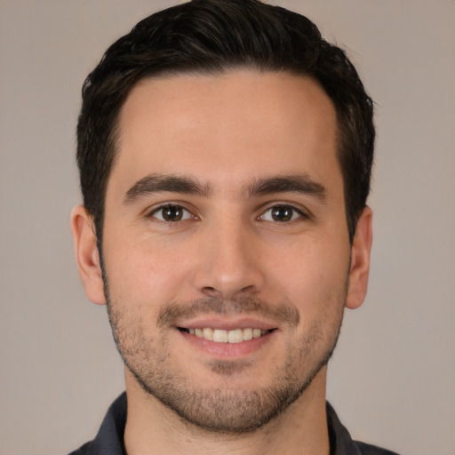 Joyful white young-adult male with short  brown hair and brown eyes