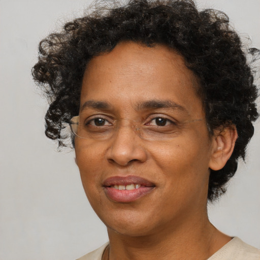 Joyful black adult female with short  brown hair and brown eyes