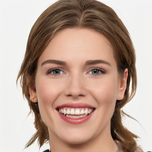 Joyful white young-adult female with medium  brown hair and green eyes