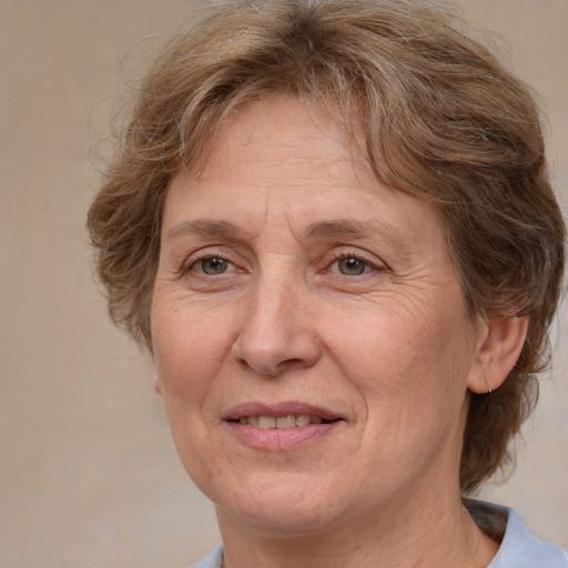 Joyful white middle-aged female with medium  brown hair and grey eyes