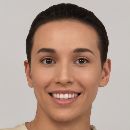 Joyful white young-adult female with short  brown hair and brown eyes