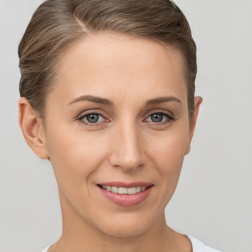 Joyful white young-adult female with short  brown hair and brown eyes