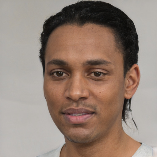 Joyful white young-adult male with short  black hair and brown eyes