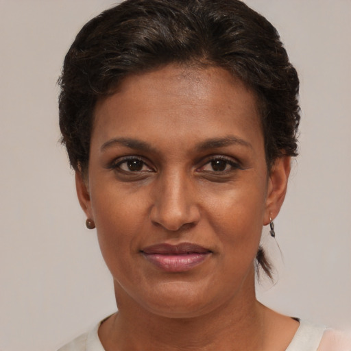 Joyful black young-adult female with short  brown hair and brown eyes