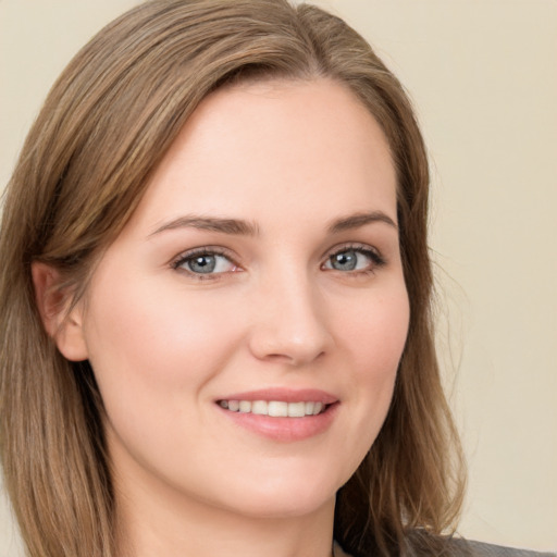 Joyful white young-adult female with long  brown hair and green eyes