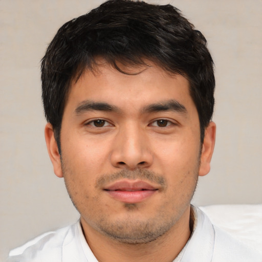Joyful asian young-adult male with short  brown hair and brown eyes