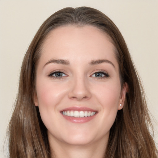 Joyful white young-adult female with long  brown hair and grey eyes