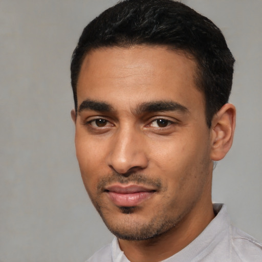 Joyful latino young-adult male with short  black hair and brown eyes