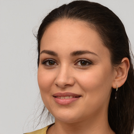 Joyful white young-adult female with long  brown hair and brown eyes