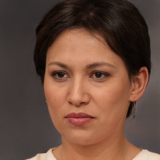 Joyful white adult female with short  brown hair and brown eyes