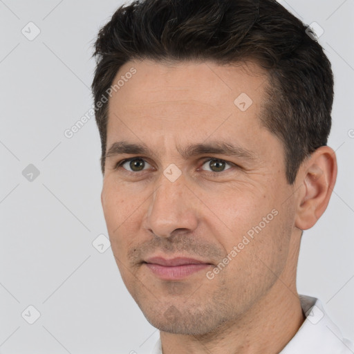 Joyful white adult male with short  brown hair and brown eyes