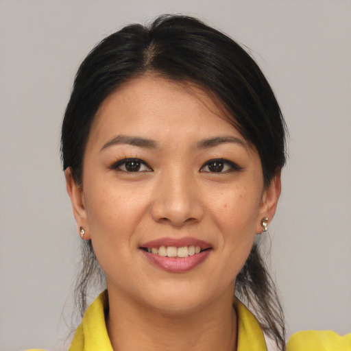 Joyful asian young-adult female with medium  brown hair and brown eyes