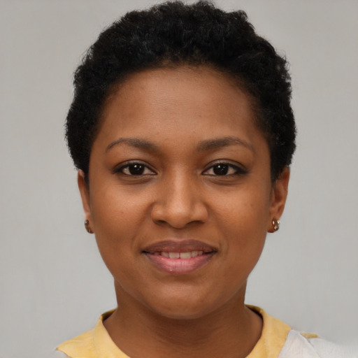 Joyful black young-adult female with short  black hair and brown eyes