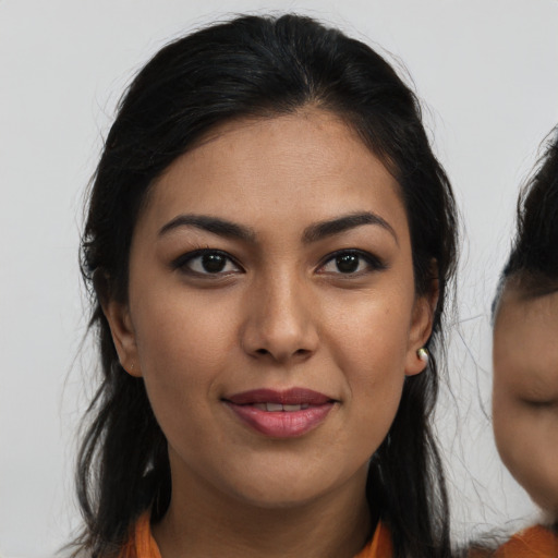 Joyful asian young-adult female with long  brown hair and brown eyes