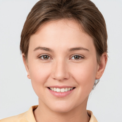 Joyful white young-adult female with short  brown hair and grey eyes