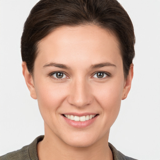 Joyful white young-adult female with short  brown hair and brown eyes