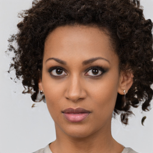 Neutral black young-adult female with medium  brown hair and brown eyes