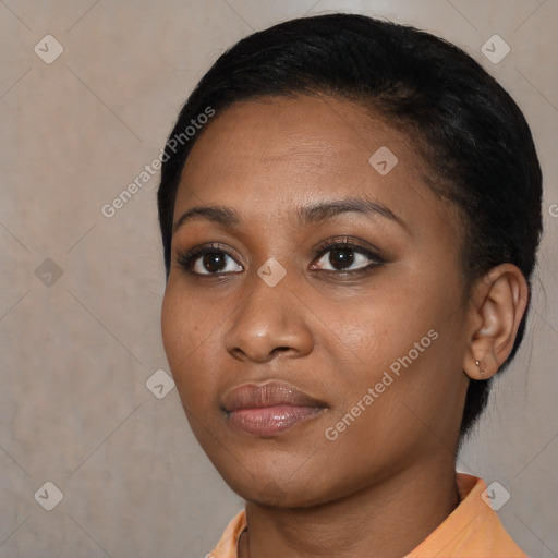 Joyful black young-adult female with short  black hair and brown eyes