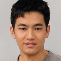 Joyful asian young-adult male with short  black hair and brown eyes