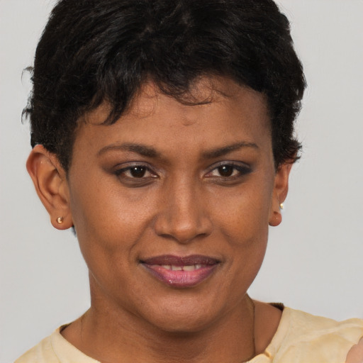 Joyful black young-adult female with short  brown hair and brown eyes