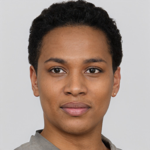 Joyful black young-adult female with short  black hair and brown eyes