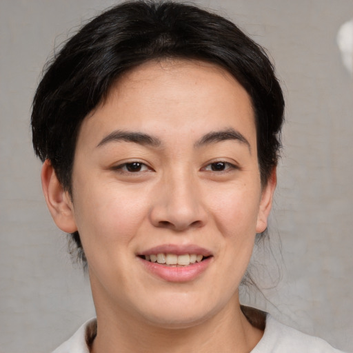 Joyful asian young-adult female with medium  brown hair and brown eyes