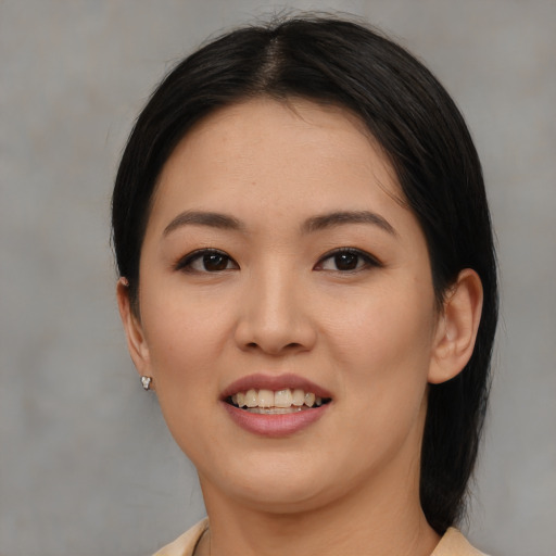 Joyful asian young-adult female with medium  brown hair and brown eyes