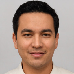 Joyful white young-adult male with short  black hair and brown eyes