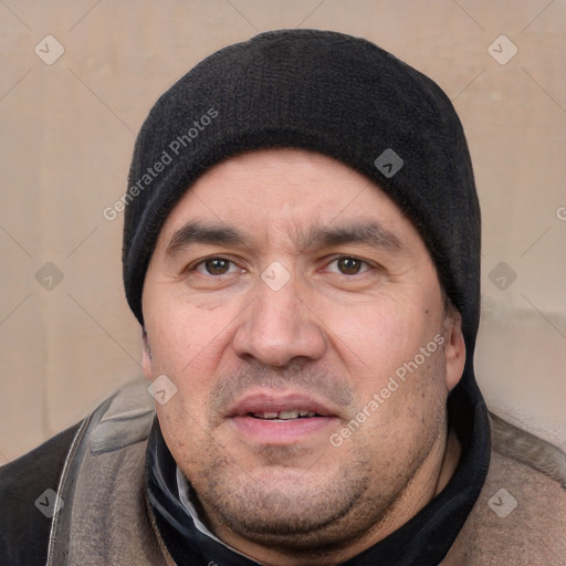 Joyful white adult male with short  black hair and brown eyes