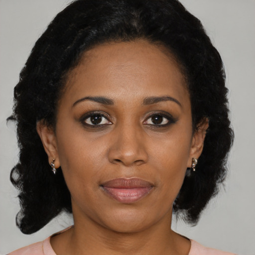 Joyful black adult female with medium  black hair and brown eyes