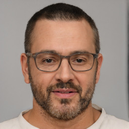 Joyful white adult male with short  brown hair and brown eyes