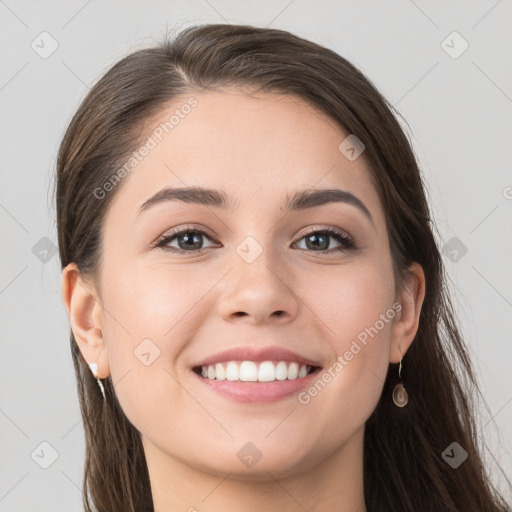 Joyful white young-adult female with long  brown hair and grey eyes