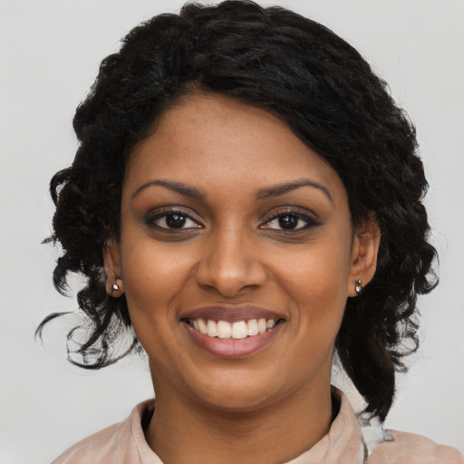 Joyful black young-adult female with medium  black hair and brown eyes