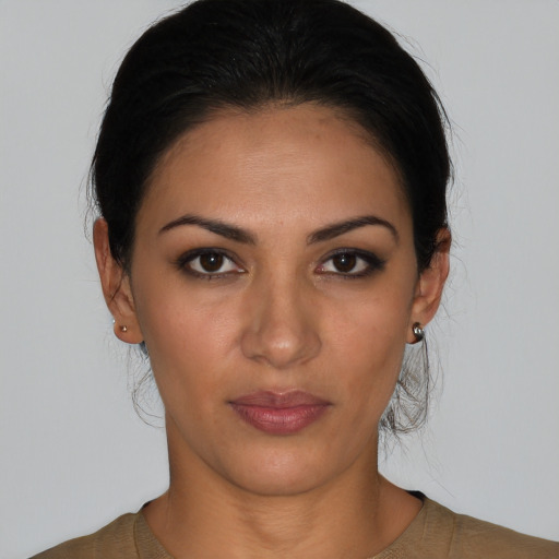 Joyful latino young-adult female with medium  brown hair and brown eyes
