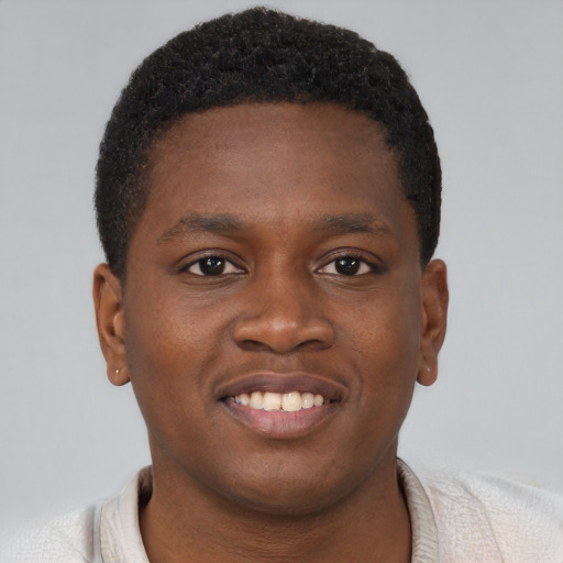 Joyful black young-adult male with short  brown hair and brown eyes