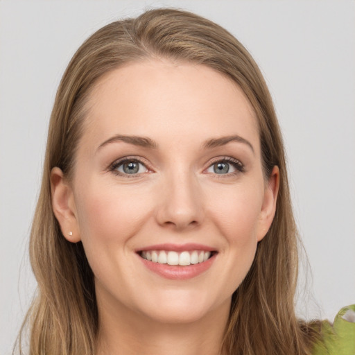 Joyful white young-adult female with long  brown hair and grey eyes