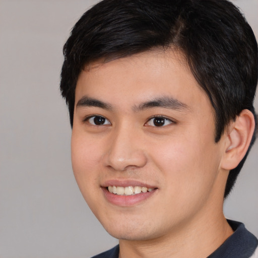 Joyful white young-adult male with short  black hair and brown eyes