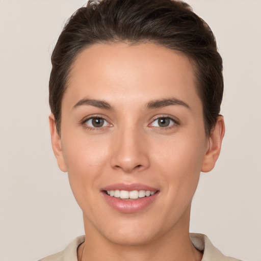 Joyful white young-adult female with short  brown hair and brown eyes