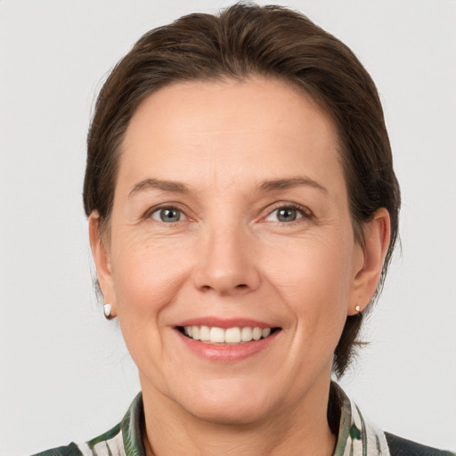 Joyful white adult female with medium  brown hair and grey eyes