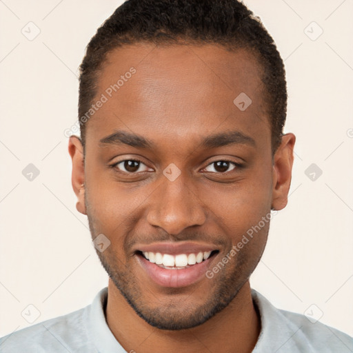 Joyful black young-adult male with short  brown hair and brown eyes