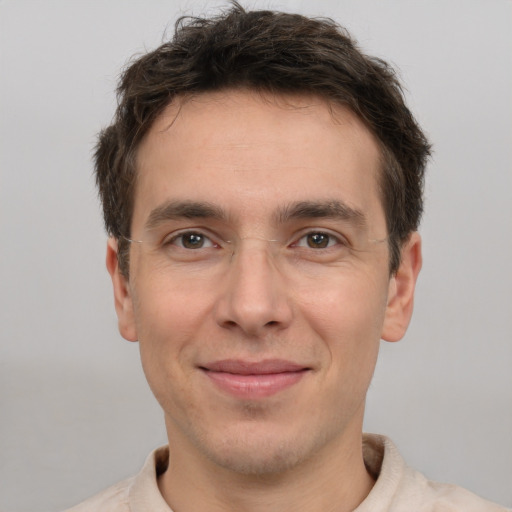 Joyful white adult male with short  brown hair and brown eyes