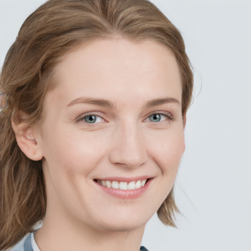 Joyful white young-adult female with medium  brown hair and blue eyes