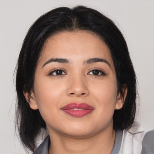 Joyful asian young-adult female with medium  black hair and brown eyes